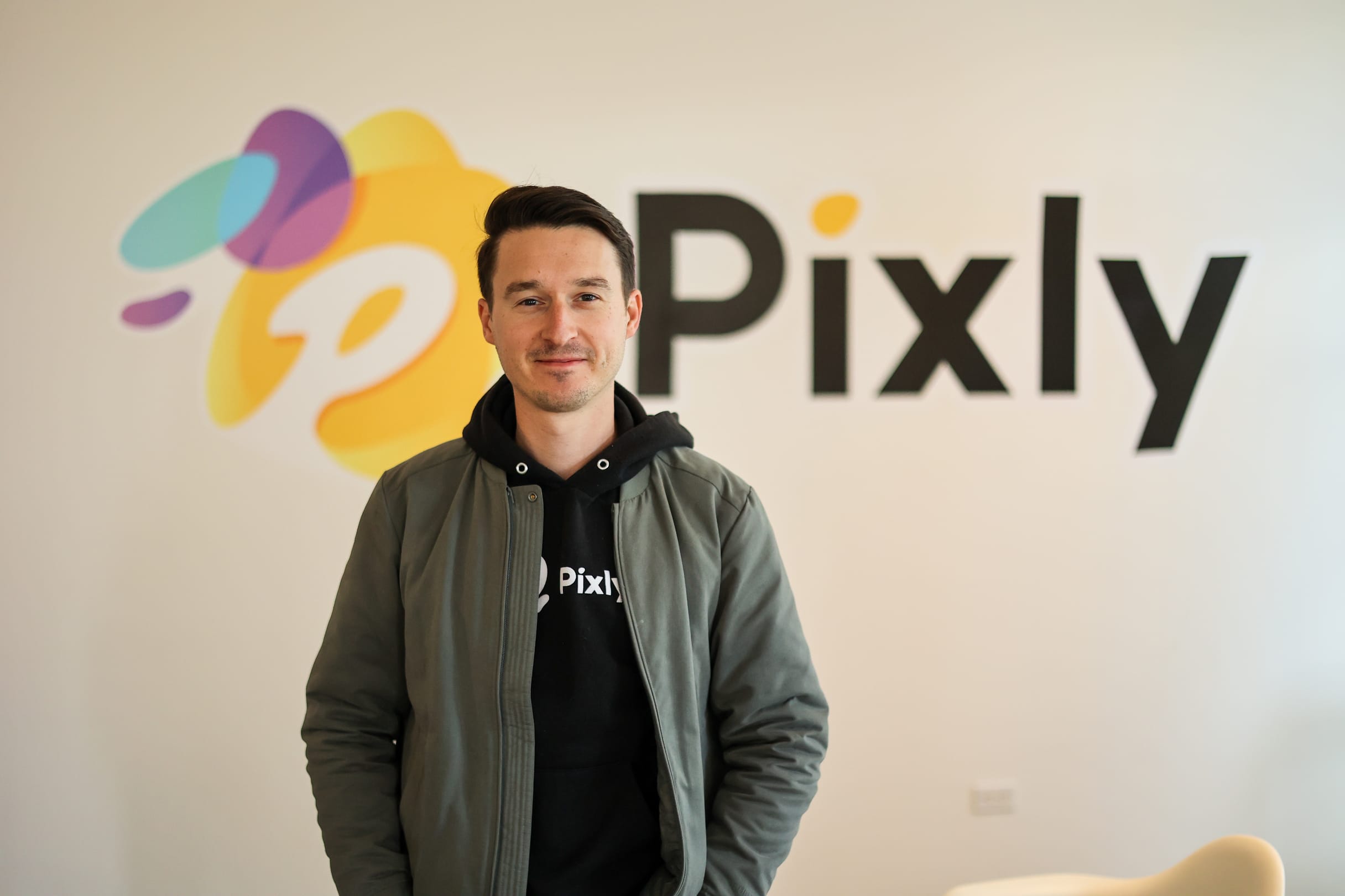 Race Johnson in front of the Pixly logo